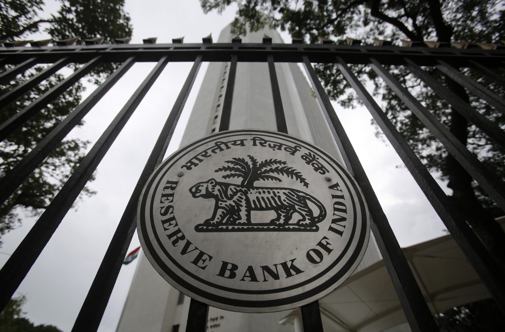 The Reserve Bank of India (RBI) seal is pictured on a gate outside the RBI headquarters in Mumbai July 30, 2013. India's central bank left interest rates unchanged on Tuesday as it supports a battered rupee but said it will roll back recent liquidity tightening measures when stability returns to the currency market, enabling it to resume supporting growth. REUTERS/Vivek Prakash (INDIA - Tags: BUSINESS LOGO) - RTX124GY