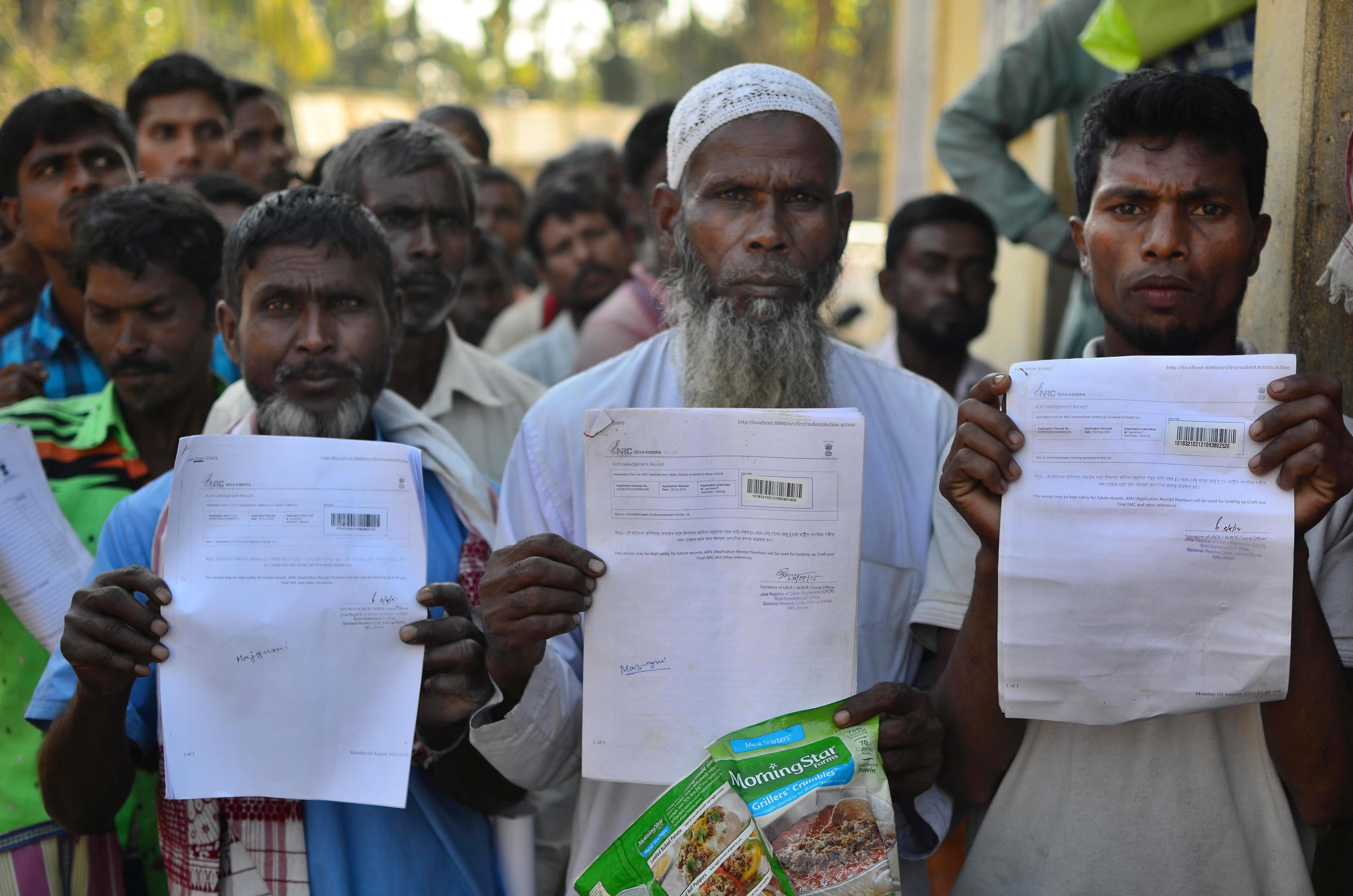 Kamrup: People show their acknowledgement receipts after checking their names in a draft for National Register of Citizens (NRC), in Guwahati on Monday. PTI Photo (PTI1_1_2018_000101B)