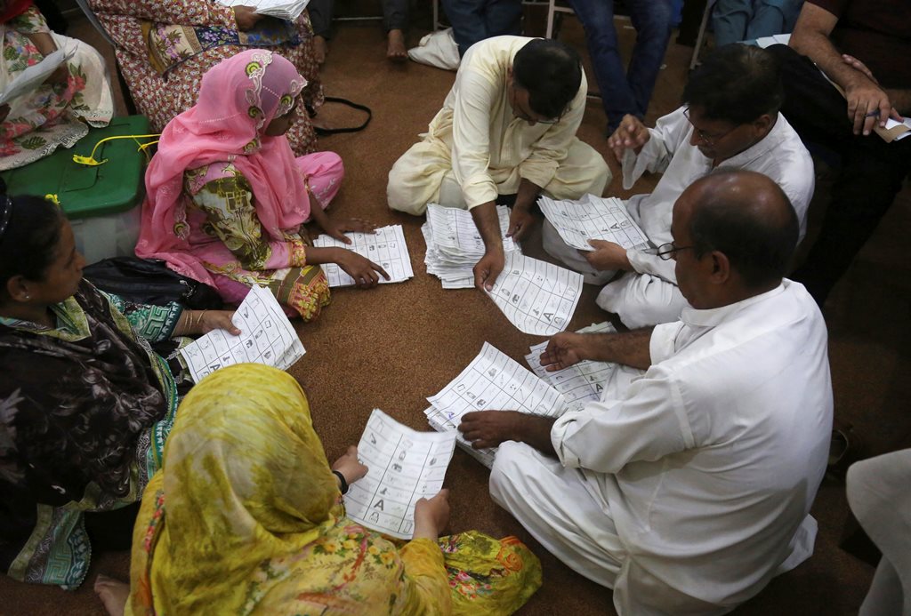 Karachi :Pakistani election staff count the votes following polls closed at a polling station for the parliamentary elections in Karachi, Pakistan, Wednesday, July 25, 2018. After an acrimonious campaign, polls opened in Pakistan on Wednesday to elect the country's third straight civilian government, a first for this majority Muslim nation that has been directly or indirectly ruled by its military for most of its 71-year history. AP/PTI Photo(AP7_26_2018_000006B)
