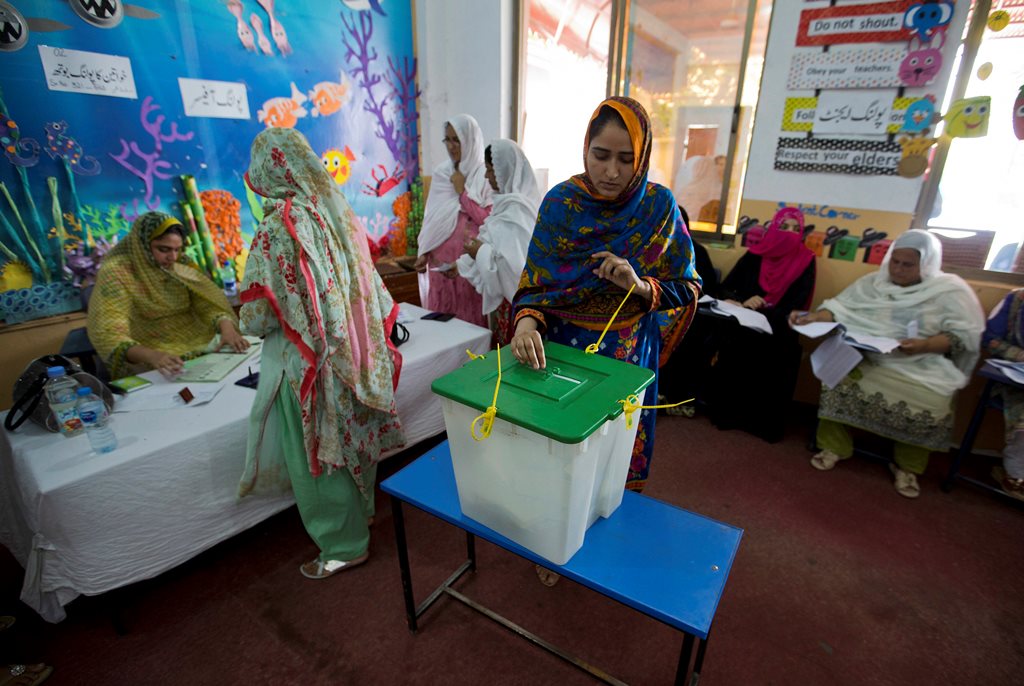 Islamabad : A Pakistani woman casts her vote at a polling station for the parliamentary elections in Islamabad, Pakistan, Wednesday, July 25, 2018. After an acrimonious campaign, polls opened in Pakistan on Wednesday to elect the country's third straight civilian election, a first for this majority Muslim nation that has been directly or indirectly ruled by its military for most of its 71-year history.AP/PTI(AP7_25_2018_000028B)