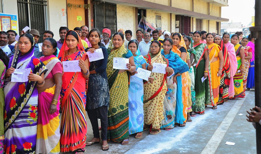 Raipur: Voters stand in a queue at a polling station to cast their votes for the 2nd phase of Assembly elections, in Raipur, Tuesday, Nov.20, 2018. (PTI Photo)(PTI11_20_2018_000037B)