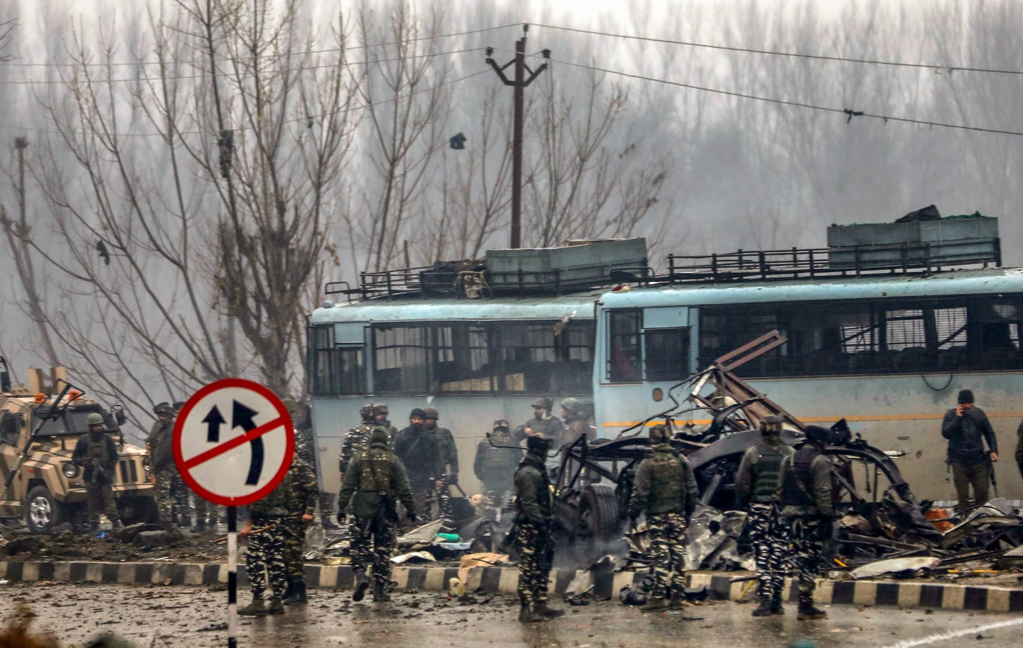 Lathepora: Security personnel carry out the rescue and relief works at the site of suicide bomb attack at Lathepora Awantipora in Pulwama district of south Kashmir, Thursday, February 14, 2019. At least 30 CRPF jawans were killed and dozens other injured when a CRPF convoy was attacked. (PTI Photo/S Irfan)  (PTI2_14_2019_000167B)
