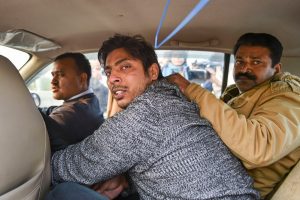 New Delhi: Police take away an unidentified person after he allegedly opened fire in the Shaheen Bagh area of New Delhi, Saturday, Feb. 1, 2020. Many anti-CAA protestors have been staging a peaceful demostration in the area for since Dec. 15, 2019. (PTI Photo/Arun Sharma) (PTI2_1_2020_000214B)