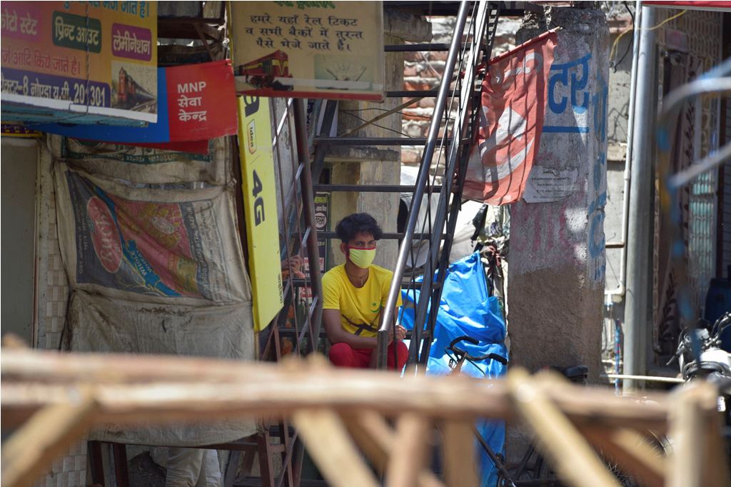 Noida: A boy sits on the staircase of his house, during a nationwide lockdown to curb the spread of coronavirus, at a slum in Noida Sec-8, Wednesday, April 8, 2020. 200 people residing in the slum were taken to a quarantine facility on Tuesday night after they were traced to being in contact with positive COVID-19 patients. (PTI Photo/Vijay Verma)(PTI08-04-2020_000091B)