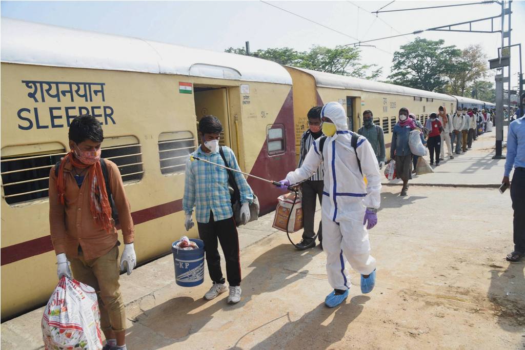 Patna: A health worker sanitizes migrants who have arrived from Jaipur by Shramik Special train at Danapur junction, during the nationwide lockdown to curb the spread of coronavirus, in Patna, Saturday, May 02, 2020. (PTI Photo)(PTI02-05-2020 000079B)