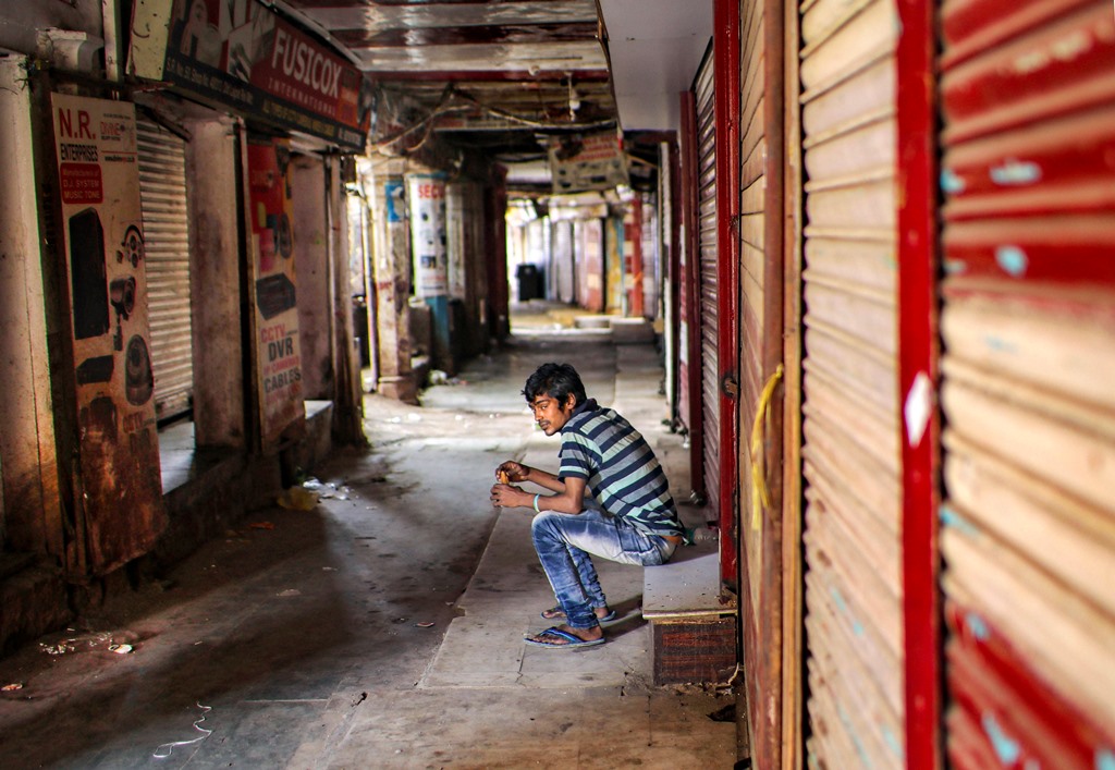 New Delhi: A man sits in front of a closed shop at deserted Lajpat Rai market in Chandni Chowk, during ongoing COVID-19 lockdown in New Delhi, Sunday, May 31, 2020. (PTI Photo/Ravi Choudhary) (PTI31-05-2020 000041B)