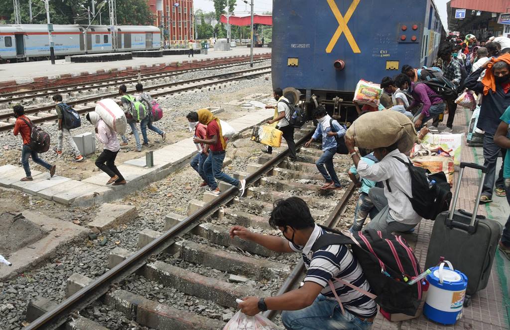 Patna: Migrants run across railway tracks after deboarding a train at Danapur railway station, during ongoing COVID-19 nationwide lockdown, in Patna, Saturday, May 30, 2020. (PTI Photo)