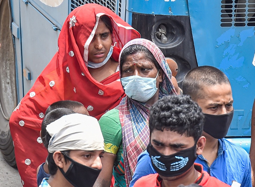 Kolkata: Migrants look for transport to reach their native places after they arrive at Howrah station by train, during the fourth phase of nationwide lockdown to curb the spread of coronavirus, in Kolkata, Saturday, May 30, 2020. (PTI Photo/Swapan Mahapatra)(PTI30-05-2020_000130B)