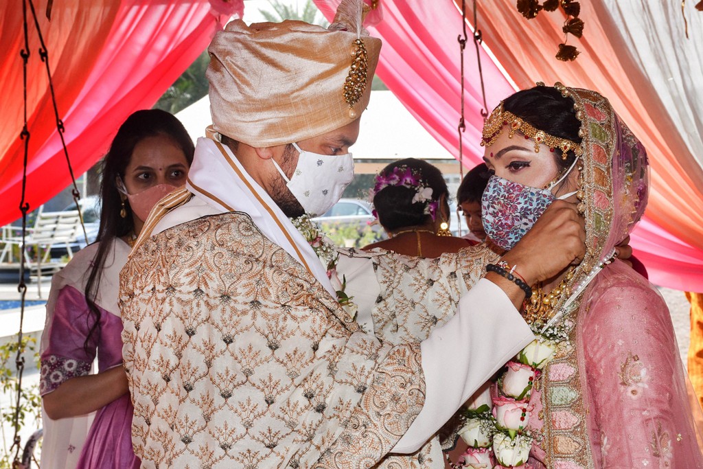 Surat: Bride and groom, wearing masks, perform rituals during their marriage ceremony amid the ongoing coronavirus pandemic, in Surat, Thursday, Nov. 26, 2020. (PTI Photo)(PTI26-11-2020 000169B)