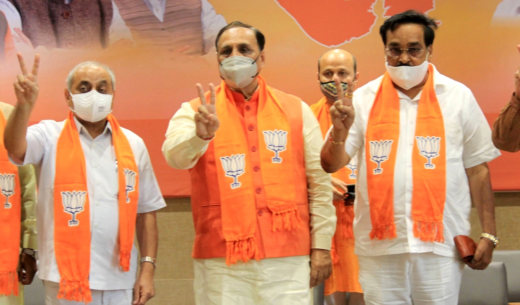 Gandhinagar: Gujarat CM Vijay Rupani (C), Deputy CM Nitin Patel (L) and BJP State President CR Patil flash the victory sign during counting of votes for Madhya Pradesh bypolls and Bihar Assembly polls, in Gandhinagar, Tuesday, Nov. 10, 2020. (PTI Photo)(PTI10-11-2020 000067B)