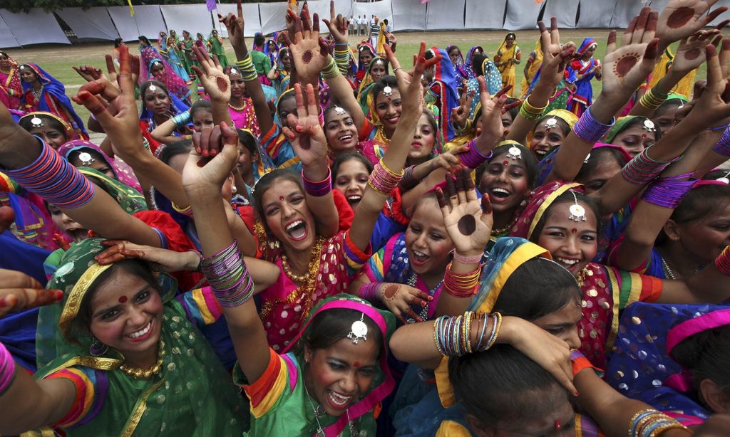 School children celebrate after being rewarded for their dance performance during India's Independence Day celebrations in Chandigarh, India, August 15, 2015. Indian Prime Minister Narendra Modi's independence day speech focused on measures his "Team India" had rolled out to include millions of poor Indians in the banking and insurance systems, policies for workers and farmers and successes in the fights against inflation and corruption. REUTERS/Ajay Verma