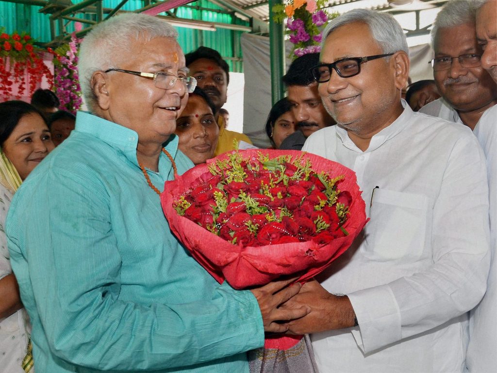 Patna: Bihar Chief Minister Nitish Kumar greeting RJD chief Lalu Prasad on his 68th birthday in Patna on Thursday. PTI Photo (PTI6_11_2015_000047A)