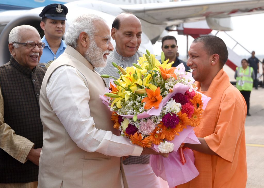 The Prime Minister, Shri Narendra Modi being received by the Governor of Uttar Pradesh, Shri Ram Naik, the Union Home Minister, Shri Rajnath Singh and the Uttar Pradesh Chief Minister designate Yogi Adityanath, on his arrival, at Lucknow, Uttar Pradesh on March 19, 2017.