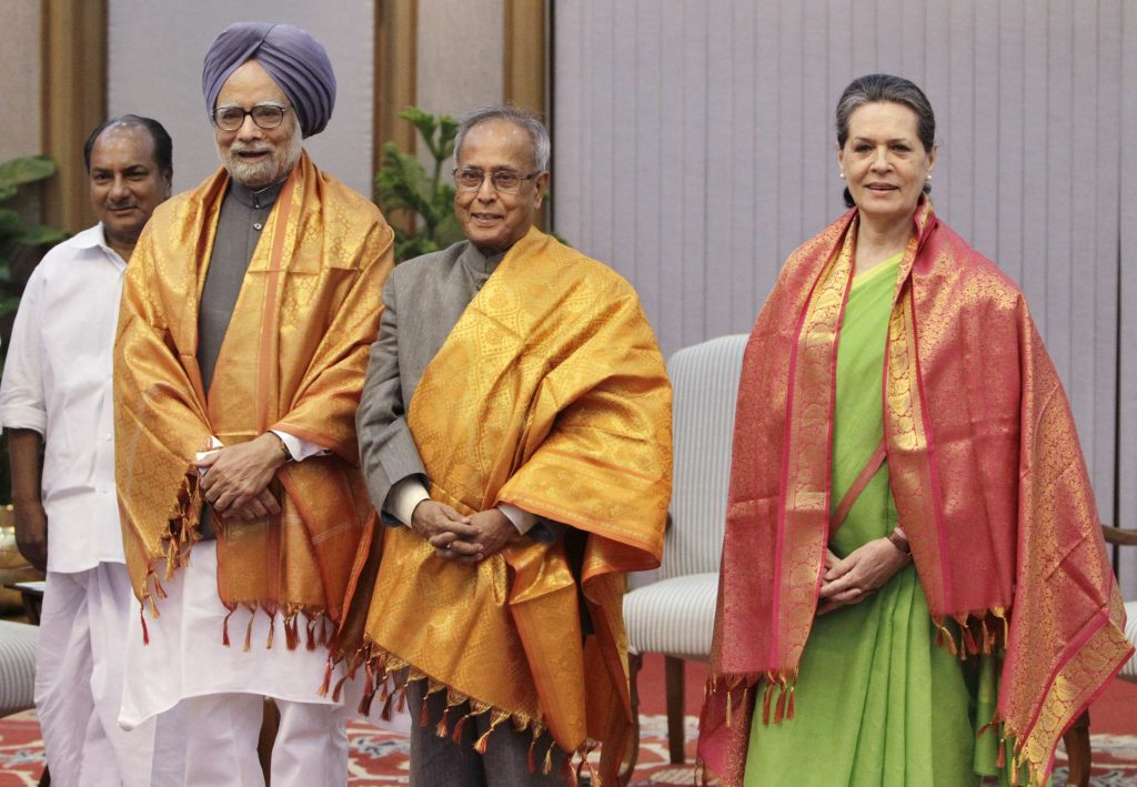 Indian Prime Minister Manmohan Singh (2nd L), Chief of India's ruling Congress party Sonia Gandhi (R) and India's Finance Minister Pranab Mukherjee (C) pose for pictures as India's Defence Minister A.K. Antony (L) watches after the United Progressive Alliance (UPA) meeting in New Delhi June 15, 2012. The ruling UPA named Finance Minister Pranab Mukherjee as its nominee for president after a week of political turmoil that exposed the fragility of the coalition government as it struggles to contain an economic crisis. REUTERS/B Mathur (INDIA)