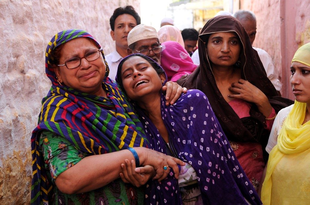 Family members of Mohammad Akhlaq (50-year-old man) mourn during his funeral at their village in Bisada on September 29, 2015 in Greater Noida, India. Akhlaq was beaten to death and his son critically injured by a mob over an allegation of storing and consuming beef at home, late night on Monday, in UPs Dadri. Police and PAC were immediately deployed in the village to maintain law and order. Six persons were arrested in connection with the killing of man. PTI