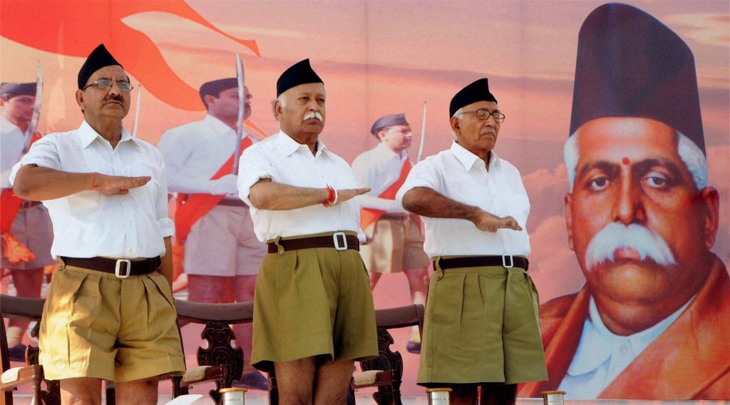 New Delhi: File photo of RSS Chief Mohan Bhagwat (C) during the RSS function. Khaki shorts, the trademark RSS dress for 91 years, is on its way out, making way for brown trousers, the significant makeover decision was taken here at an RSS conclave in Nagaur, Rajasthan on Sunday. PTI Photo (PTI3_13_2016_000268B)