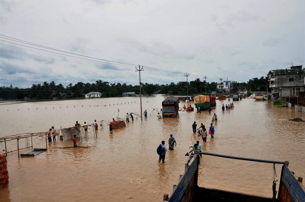 Agartala: People wade through a flooded road at Pratapgarh in Agartala, Tripura on Friday. PTI Photo (PTI6_2_2017_000036A)