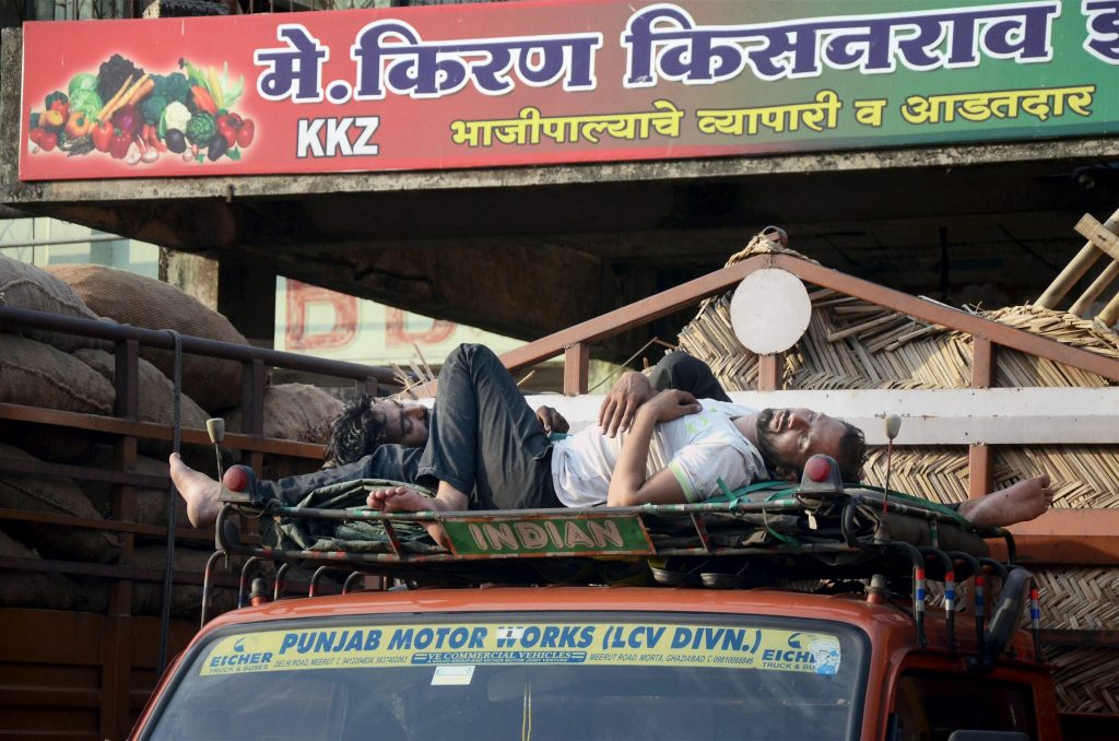 Navi Mumbai: A driver takes nap on a truck ar APMC Vegetable Market on the second day of farmers' strike in Navi Mumbai on Friday. PTI Photo (PTI6_2_2017_000114B)