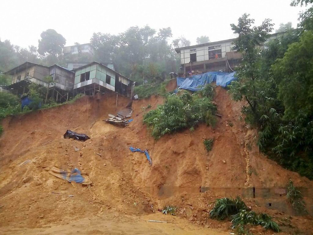Aizawl: The earth under the buildings caves in after heavy rains triggered landslides in Aizawl, Mizoram on Tuesday. PTI Photo (PTI6_14_2017_000058B)