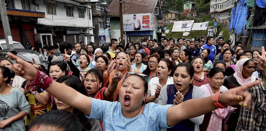 Darjeeling: GJM supporters shout slogans at a protest rally during their indefinite bandh in Darjeeling on Monday. PTI Photo by Ashok Bhaumik (PTI6_19_2017_000132A)