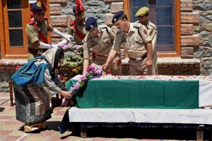 Srinagar: Jammu and Kashmir Chief Minister Mehbooba Mufti laying a wreath at the coffin of slain DSP Mohammed Ayub Pandit during a ceremony at District Police Lines in Srinagar on Friday. Pandit was reportedly lynched to death by the mob outside historic Jamia Masjid in Nowhatta area of Srinagar. PTI Photo by S Irfan