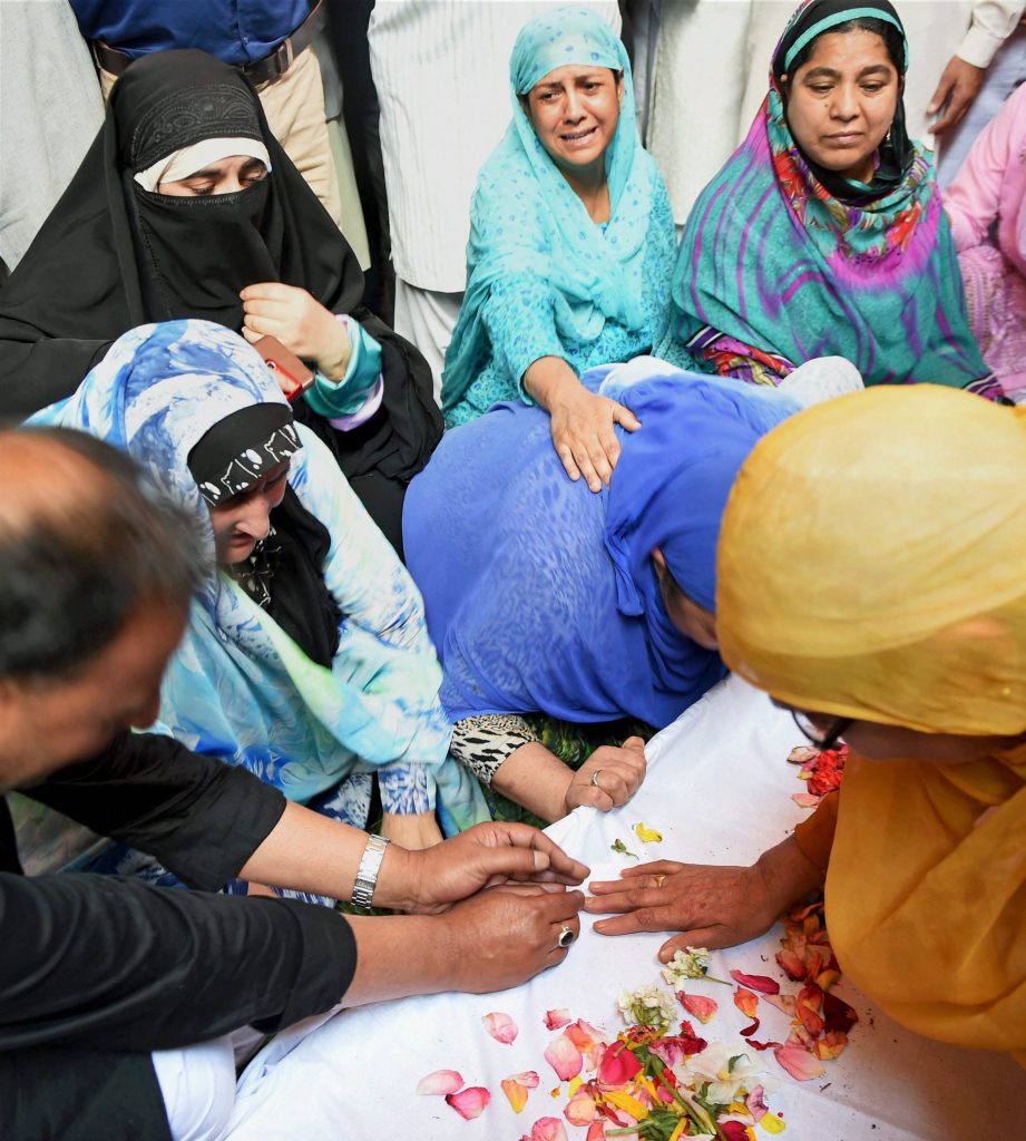 Srinagar: Family members and relatives wail near the coffin of DySP Mohammad Ayoub Pandith at his residence in Srinagar on Friday. Pandith was lynched to death by a mob outside the historic Jamia Masjid in downtown Srinagar in the wee hours on Friday. PTI Photo by S Irfan  (PTI6_23_2017_000141B)
