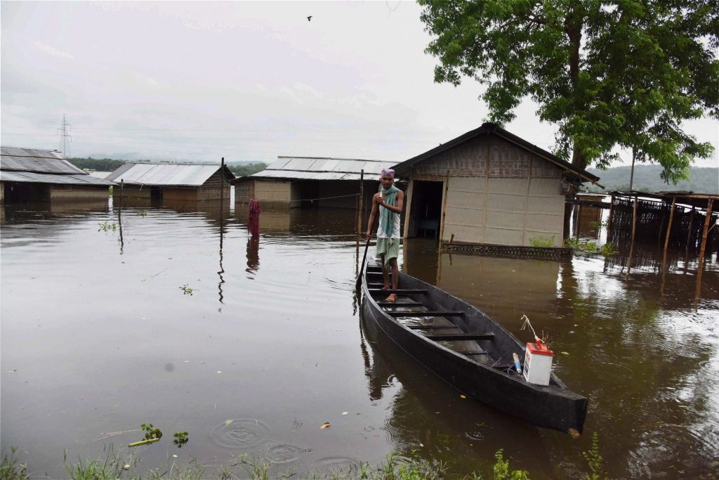 Kaziranga: A man sails his boat in the flood-affected Kuthori village near Kaziranga National Park in Nagaon district of Assam on Monday. PTI Photo (PTI7_10_2017_000149A)