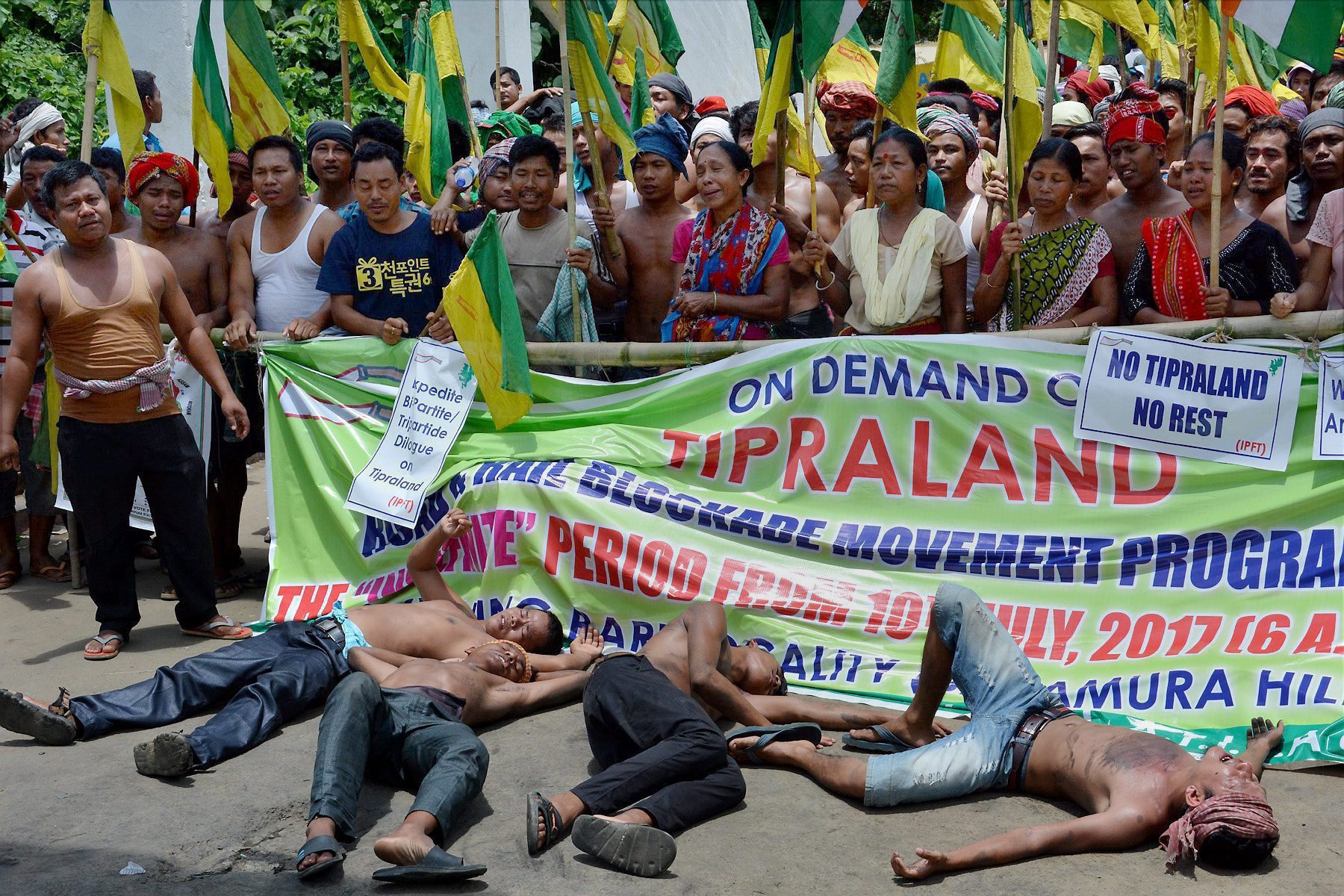 Agartala: Supporters of Indigeneous Peoples Front of Twipra (IPFT) shout slogans as they block national highway (NH-44) to demand for a separate of Tipraland state at Khamtingbari, Baramura Hill range, some 36 km north of Agartala on Sunday. PTI Photo (PTI7_16_2017_000285A)