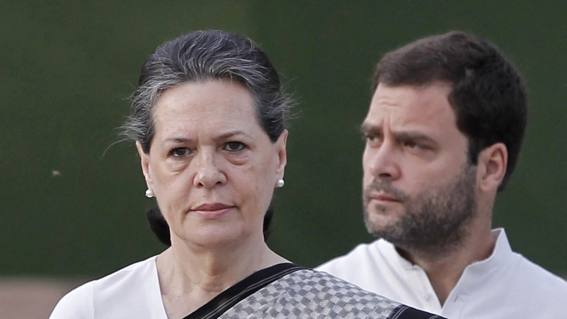 Chief of India's ruling Congress party Sonia Gandhi (L) pays tribute at her husband Rajiv Gandhi's memorial as her son and a lawmaker Rahul Gandhi watches on the 21st anniversary of the former Prime Minister's death in New Delhi May 21, 2012. Rajiv Gandhi was killed by a female suicide bomber during election campaigning on May 21, 1991. REUTERS/Adnan Abidi (INDIA - Tags: POLITICS OBITUARY ANNIVERSARY) - RTR32E0R