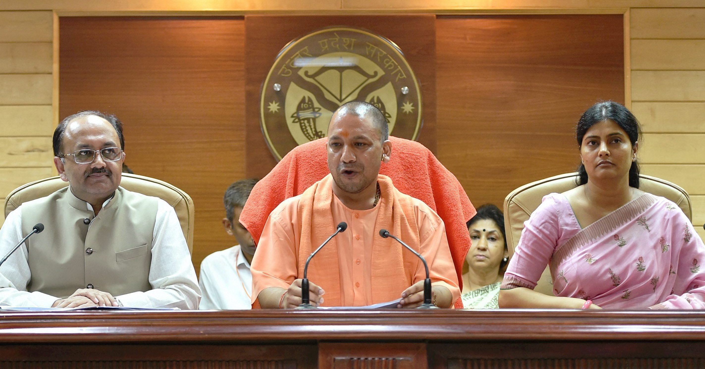 Lucknow: Uttar Pradesh Chief Minister Yogi Aditiyanath addressing a press conference in Lucknow on Saturday. Union Minister Anupriya Patel and Uttar Pradesh Health Minister Siddharth Nath Singh are also seen. PTI Photo by Nand Kumar (PTI8_12_2017_000138B)