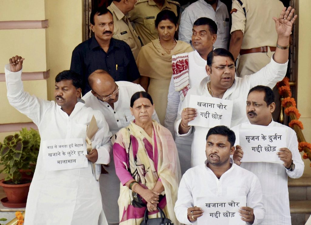 (RPT)... Patna: RJD senior leader Rabri Devi and legislators stage a demonstration on Srijan scam outside the Bihar Assembly during the Monsoon session of the House in Patna on Monday. PTI Photo(PTI8_21_2017_000011B)