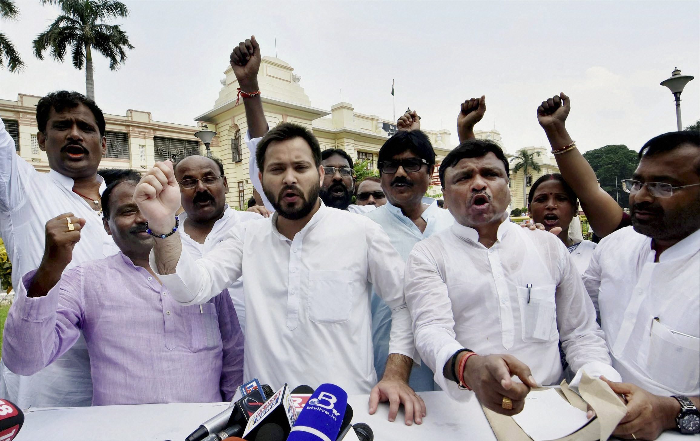 Patna: Leader of Opposition in the Bihar Assembly Tejashwi Yadav along with Congress legislators staged a walk out from the Assembly in protest over the Srijan scam, in Patna on Wednesday. PTI Photo (PTI8_23_2017_000036A)