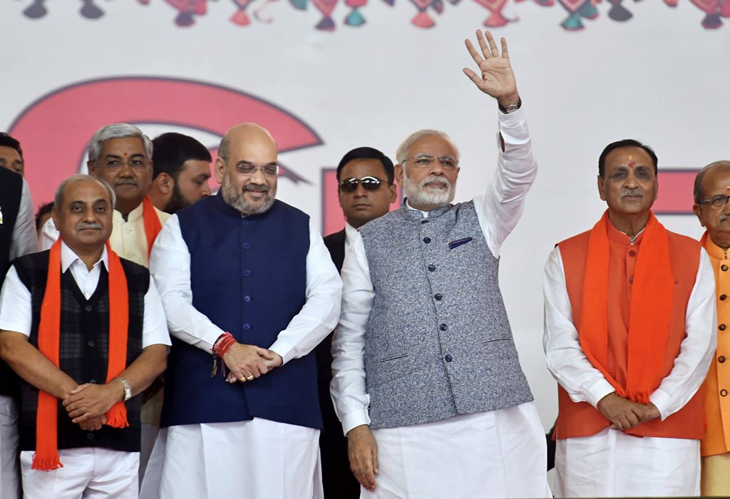 Gandhinagar: Prime Minister Narendra Modi, BJP President Amit Shah along with new CM Vijay Rupani and other state ministers during the swearing-in ceremony at Gandhinagar, Ahmedabad in Gujarat on Tuesday. PTI Photo by Santosh Hirlekar(PTI12_26_2017_000028B)