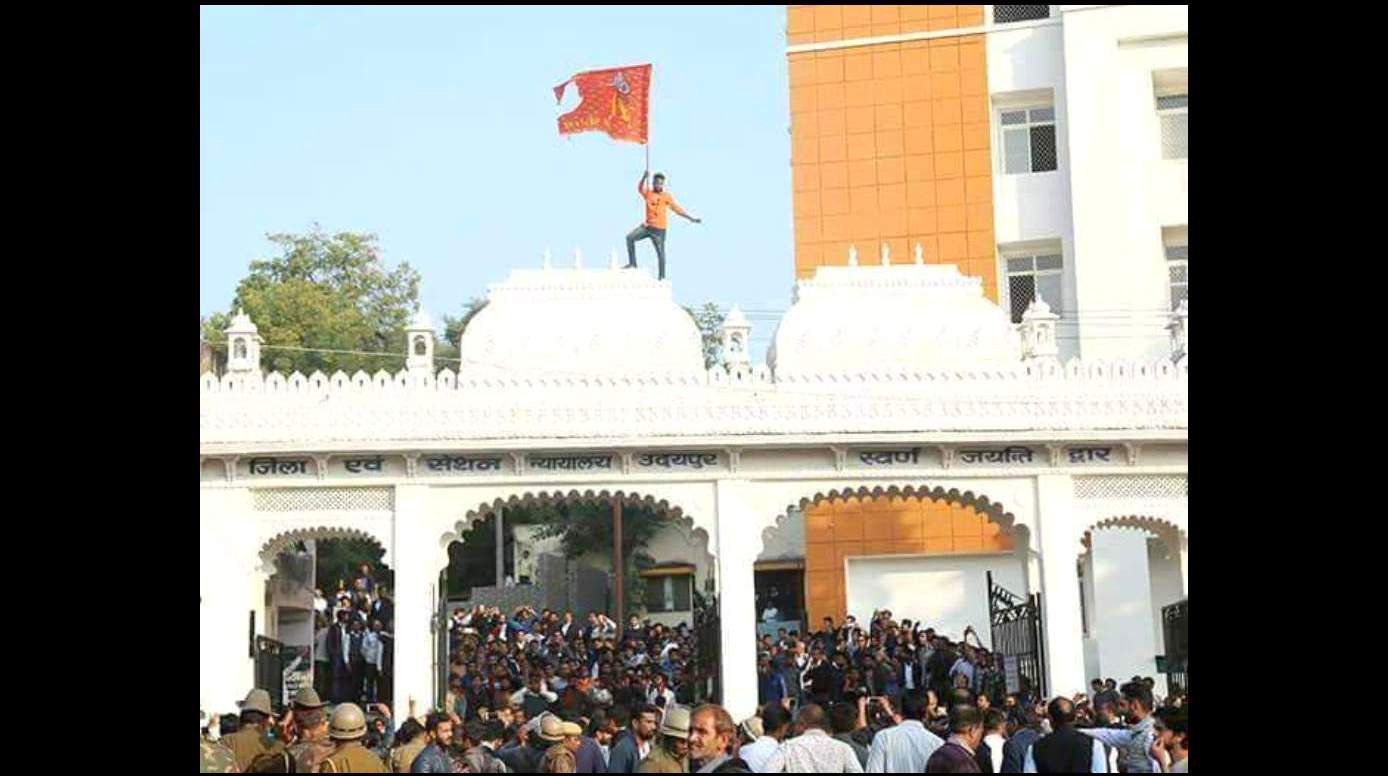 उदयपुर की अदालत की छत पर भगवा झंडा फहराता युवक. (फोटो साभार: दैनिक भास्कर)