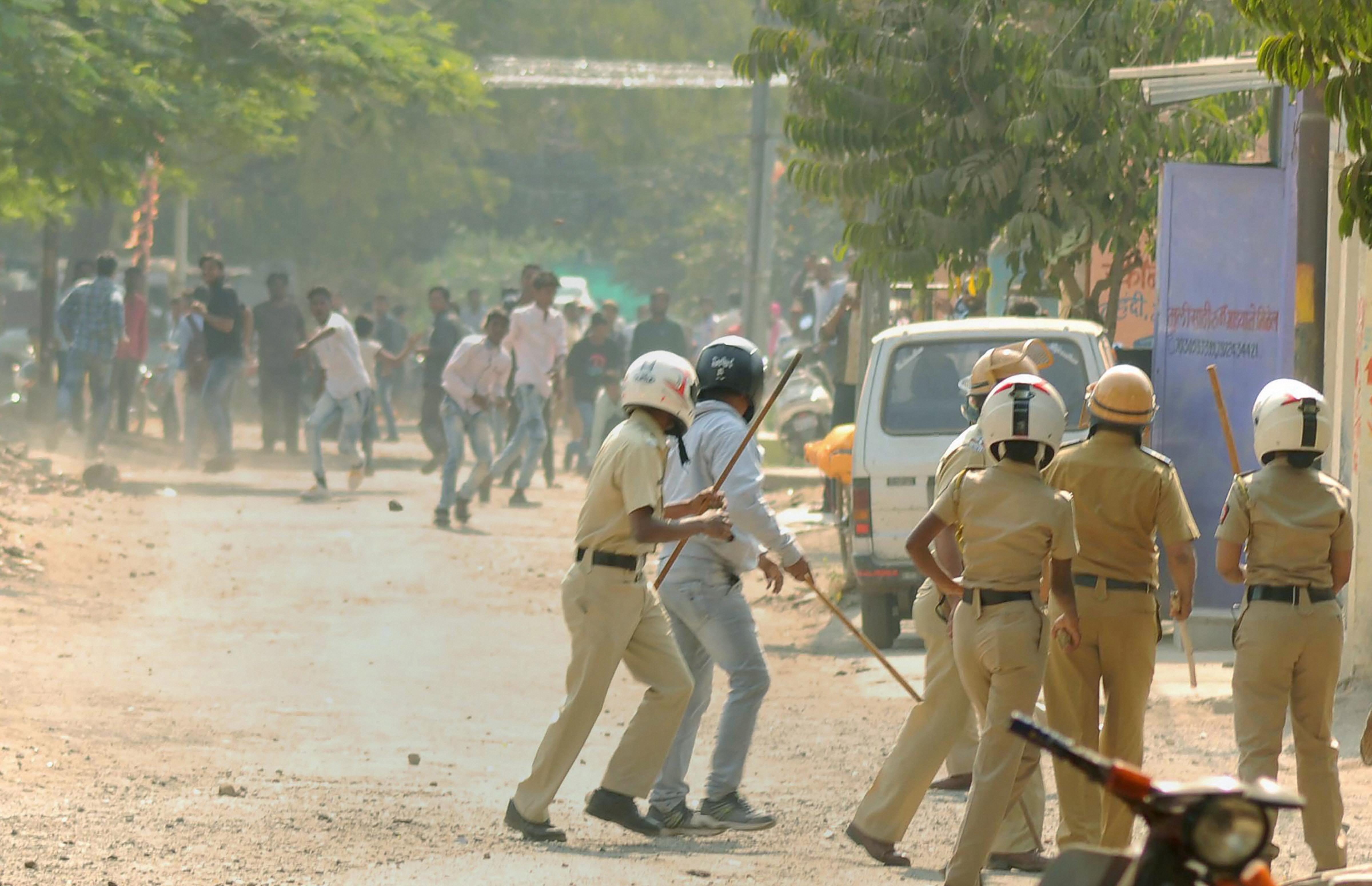 Aurangabad: RPI activists pelting stones at the police during their violent protest in Aurangabad on Tuesday, over the clashes that broke out at 200th anniversary celebrations of the Battle of Bhima in Koregaon, near Pune. PTI Photo (PTI1_2_2018_000115B)