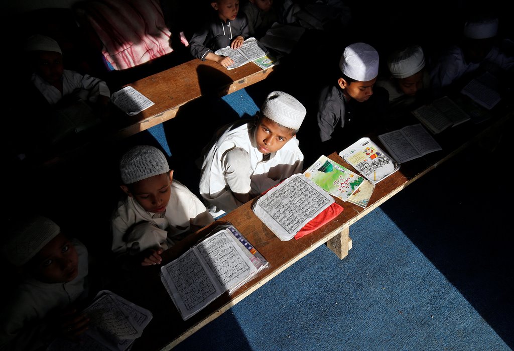 Children belonging to Rohingya Muslim community read Koran at a madrasa, or a religious school, at a makeshift settlement, on the outskirts of Jammu, May 6, 2017. Picture taken on May 6, 2017. REUTERS/Mukesh Gupta