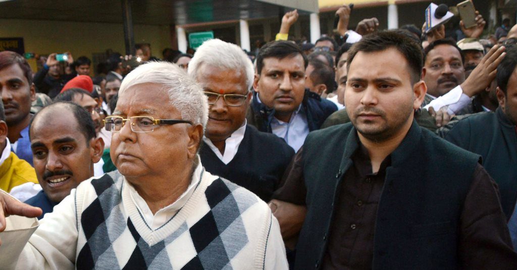 Ranchi: RJD supremo Lalu Prasad Yadav escorted by police officials after being convicted by the special CBI court in a fodder scam case, in Ranchi on Saturday. PTI Photo(PTI12_23_2017_000111B)