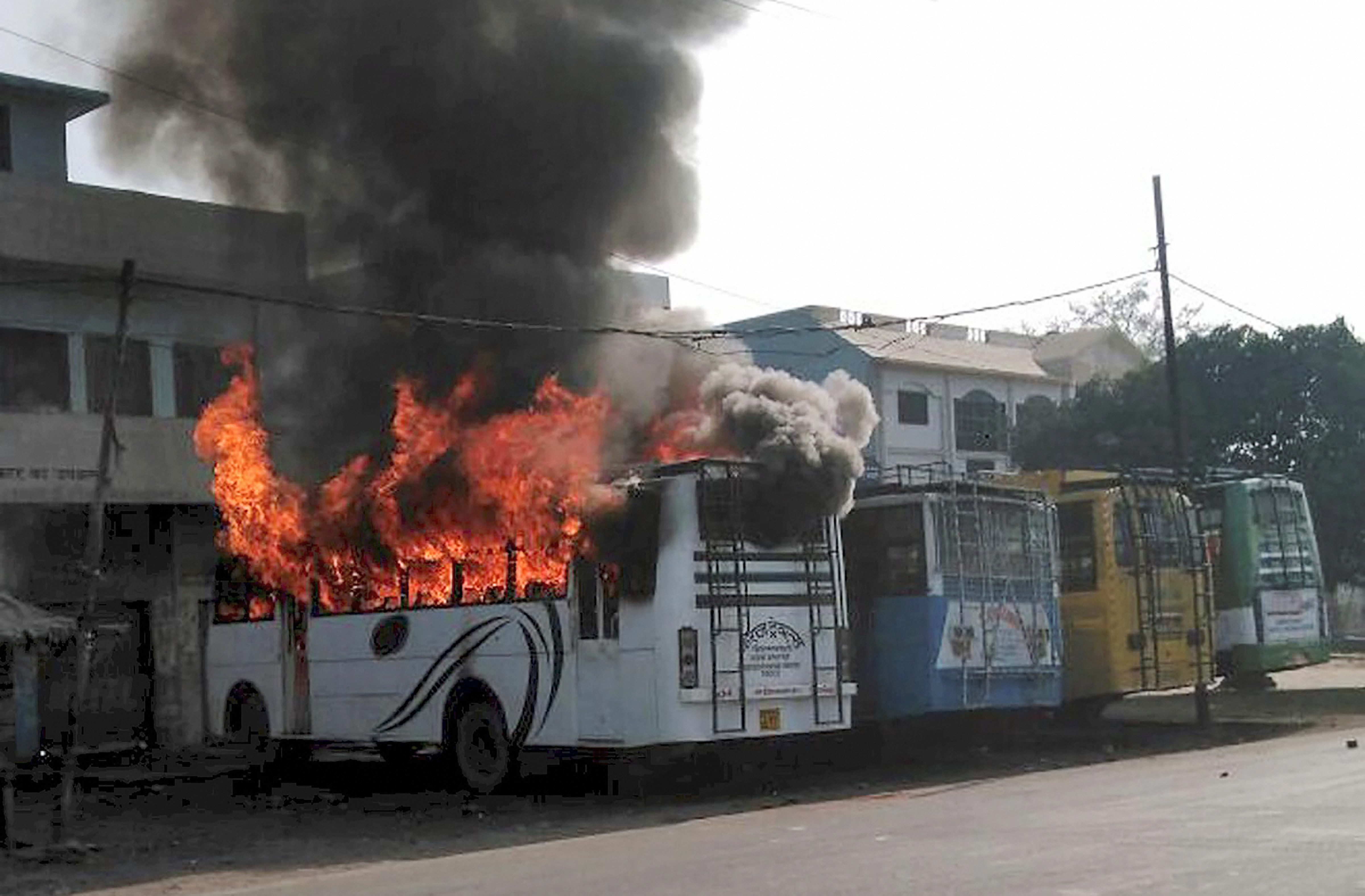 Kasganj: A bus set on fire by a group of people who went on a rampage after the cremation of a young man killed on Friday during the Tiranga bike rally, in Kasganj on Saturday. PTI Photo (PTI1_27_2018_000204B) *** Local Caption ***