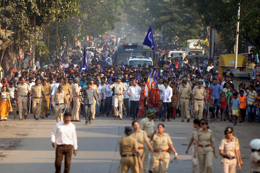 Mumbai: Policemen accompany the Dalits protestors as they stage a protest against the violence in Bhima Koregaon area of Pune, in Mumbai on Tuesday. PTI Photo by Shashank Parade (PTI1_2_2018_000159B)