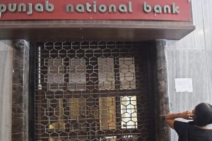 Mumbai: A woman looks on as CBI team seals Punjab National Bank’s South Mumbai branch at Brady House in Mumbai on Monday. The PNB fraud case involving jeweller Nirav Modi was allegedly carried out of this branch. PTI Photo by Shashank Parade (PTI2_19_2018_000088B)