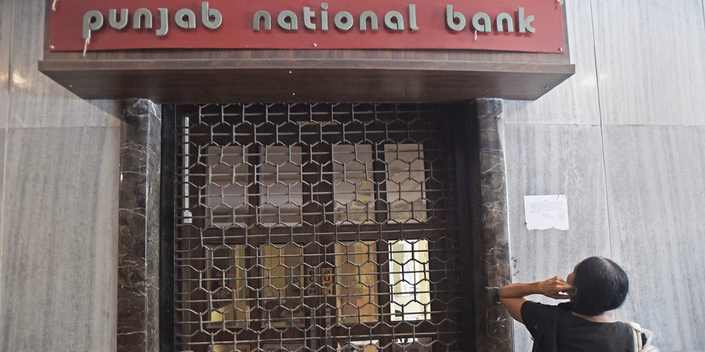 Mumbai: A woman looks on as CBI team seals Punjab National Bank’s South Mumbai branch at Brady House in Mumbai on Monday. The PNB fraud case involving jeweller Nirav Modi was allegedly carried out of this branch. PTI Photo by Shashank Parade (PTI2_19_2018_000088B)