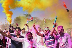 Bikaner: Congress workers celebrate with colours the party's win in Mandalgarh assembly constituency, and its decisive leads in Ajmer and Alwar parliamentary constituencies, in Bikaner on Thursday. PTI Photo (PTI2_1_2018_000082B)