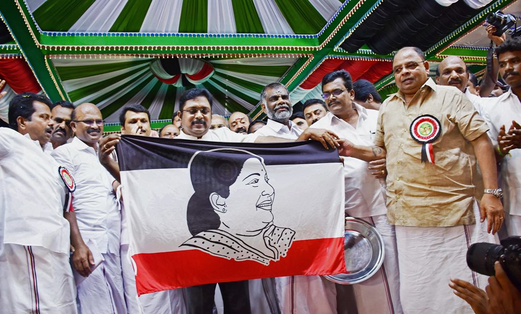 Madurai: Sidelined AIADMK leader TTV Dhinakaran launches the party flag which consists of a photo of former TN chief minister J Jayalalitha during the launch of his political party Amma Makkal Munnetra Kazhagam in Madurai on Thursday. PTI Photo (PTI3_15_2018_000041B)