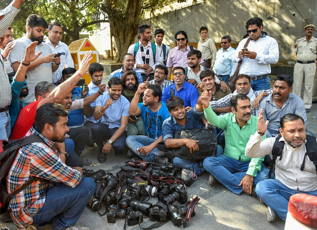 New Delhi: Photo-journalists from various organization protest outside the Police Headquarters against alleged groping and manhandling of two female journalists by the Delhi Police, in New Delhi, on Saturday. PTI Photo by Ravi Choudhary (PTI3_24_2018_000110B)