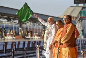 Varanasi : Prime Minister Narendra Modi flagging off the train between Maduadih and Patna, at Maduadih, in Varanasi, Uttar Pradesh on Monday. The Chief Minister of Uttar Pradesh, Yogi Adityanath is also seen.PTI Photo/PIB (PTI3_12_2018_000192B)