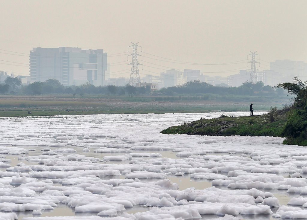 New Delhi: A view of foam-covered water, as a result of pollution, as seen from the banks of river Yamuna, near Kalindi Kunj in New Delhi, on Monday. According to the UN, the theme for World Water Day 2018, observed on March 22, is ‘Nature for Water’ – exploring nature-based solutions to the water challenges we face in the 21st century. PTI Photo by Ravi Choudhary(PTI3_21_2018_000117B)