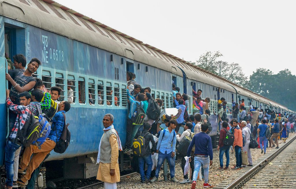 Mathura: Passengers travel in an overcrowded train ahead of Holi festival in Mathura on Thursday. PTI Photo (PTI3_1_2018_000196B)