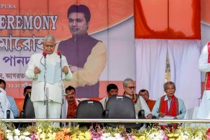 Agartala: Tripura BJP President Biplab Kumar Deb being sworn-in as the 10th chief minister of the state by Governor Tathagata Roy during a ceremony in Agartala on Friday. Prime Minister Narendra Modi is also seen on the stage. PTI Photo (PTI3 9 2018 000102B) *** Local Caption ***
