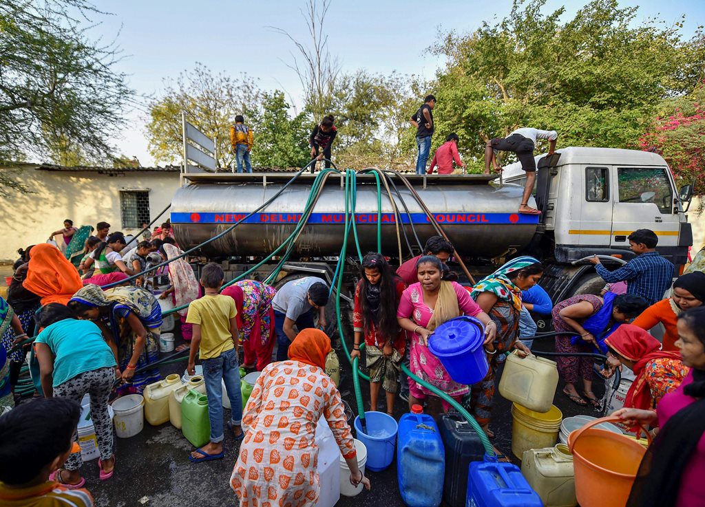 New Delhi: Residents of Vivekanand camp gather around a Municipal Corporation tanker to fill water, at Chanakyapuri in New Delhi, on Wednesday. According to the UN, the theme for World Water Day 2018, observed on March 22, is ‘Nature for Water’ – exploring nature-based solutions to the water challenges we face in the 21st century. PTI Photo by Ravi Choudhary (PTI3_21_2018_000124B)