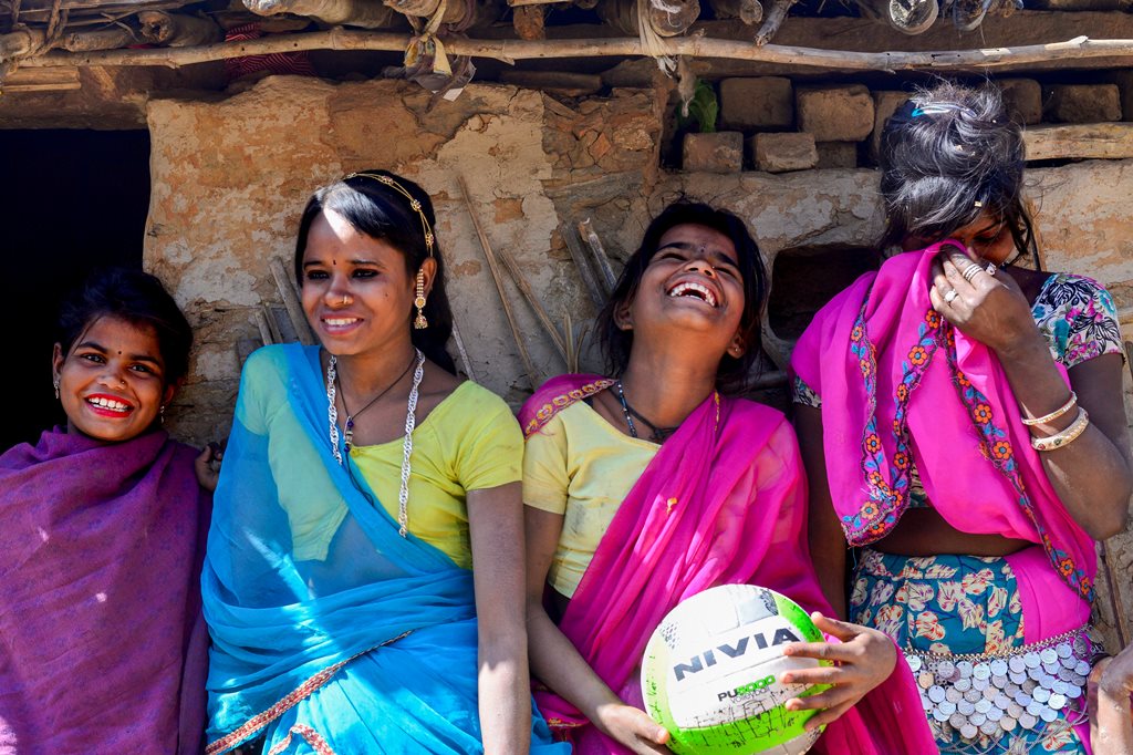 ::STANDALONE PHOTO PACKAGE:: Udaipur: Shanta (10), Meena (15), Champa (12) and Pushpa (16) in a light mood after a friendly match at village Mota Bhata in Udaipur. An NGO, Vikalp Sansthan, is training girls of this Bhil tribe in volleyball; in an attempt to try and pull them out of their homes and making them comfortable not just in the open fields of the village area but also with their own selves. The girls from this extremely remote area of Rajasthan have found a means of self expression through this simple game. International Women's Day observed on March 8th, has 'Press for Progress', which promotes gender parity as it theme this year. PTI Photo by Rohit Jain(PTI3_7_2018_000136B)